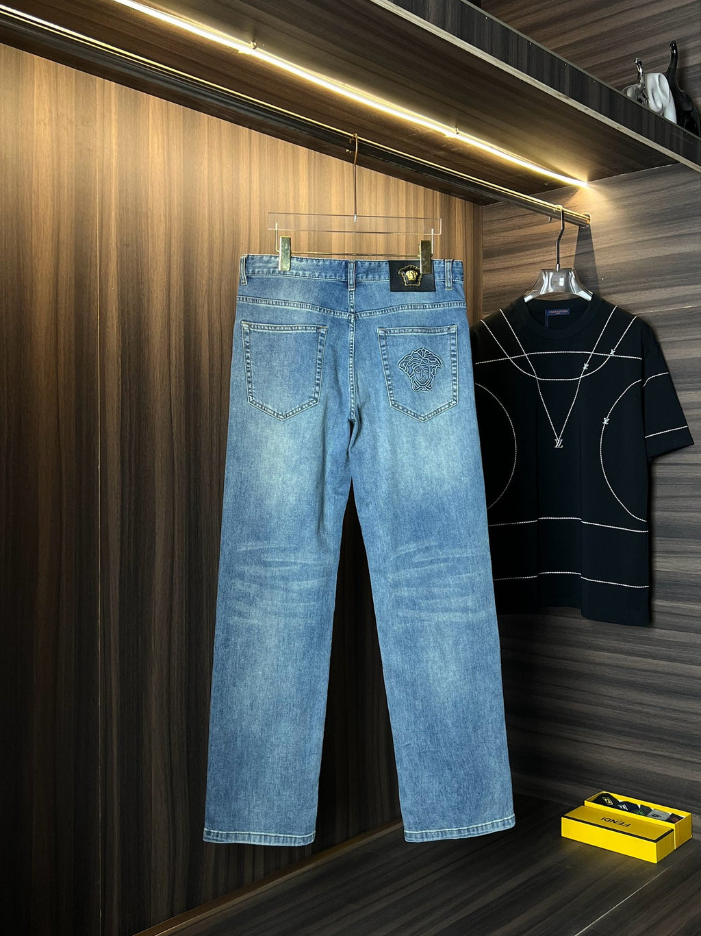 Versace light-wash wide-leg denim jeans with embroidered pocket accents and front seams