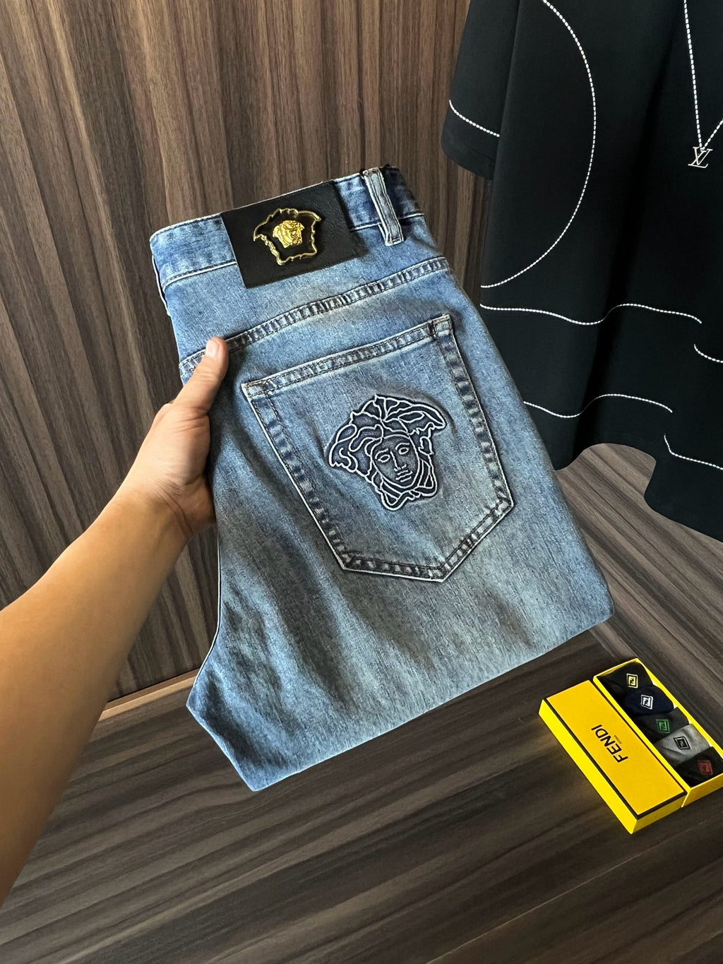 Light blue denim jeans with embroidered front and back patch details