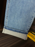 Versace light-wash denim jeans with cuffed hem and stitched lower edge