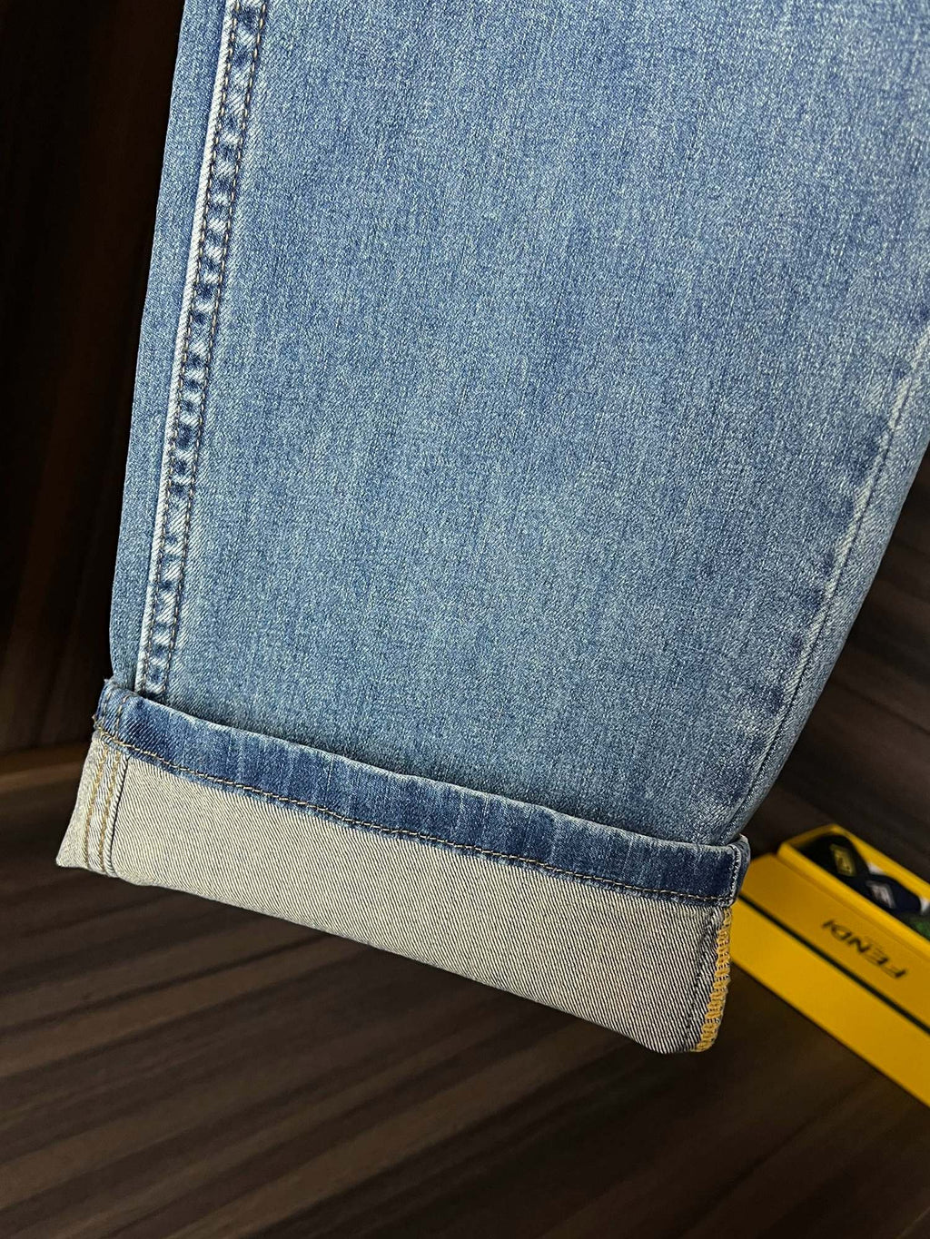Light blue denim jeans close-up of folded hem cuff at the ankle