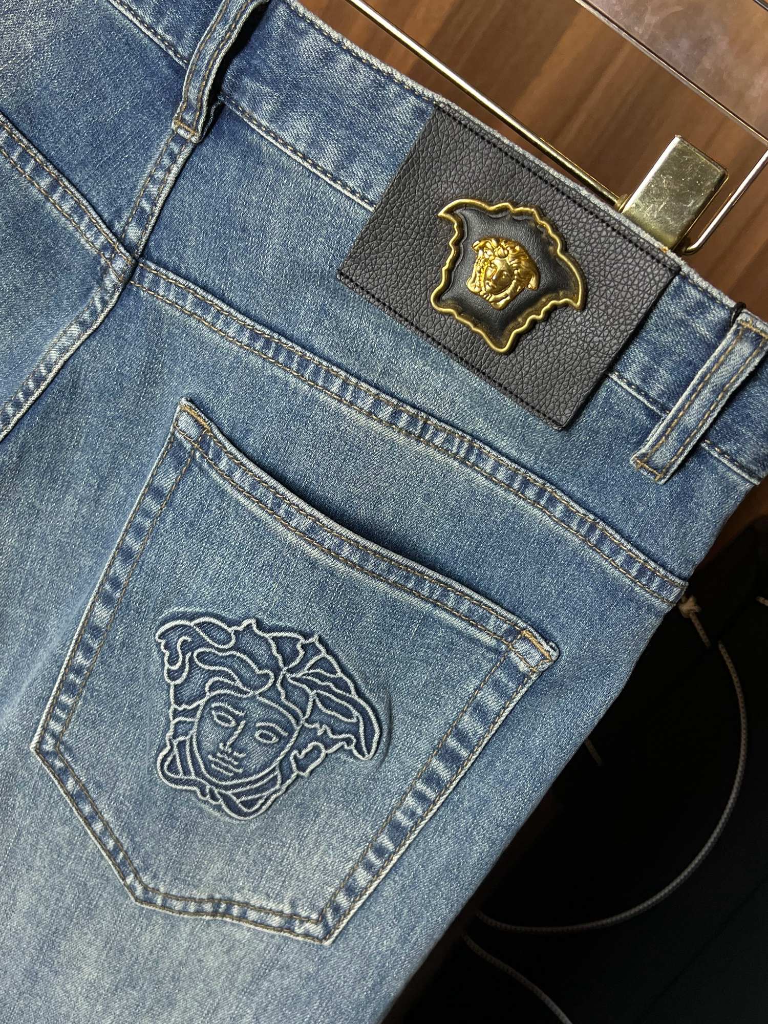 Light blue denim jeans close-up of back pocket and top patch emblem