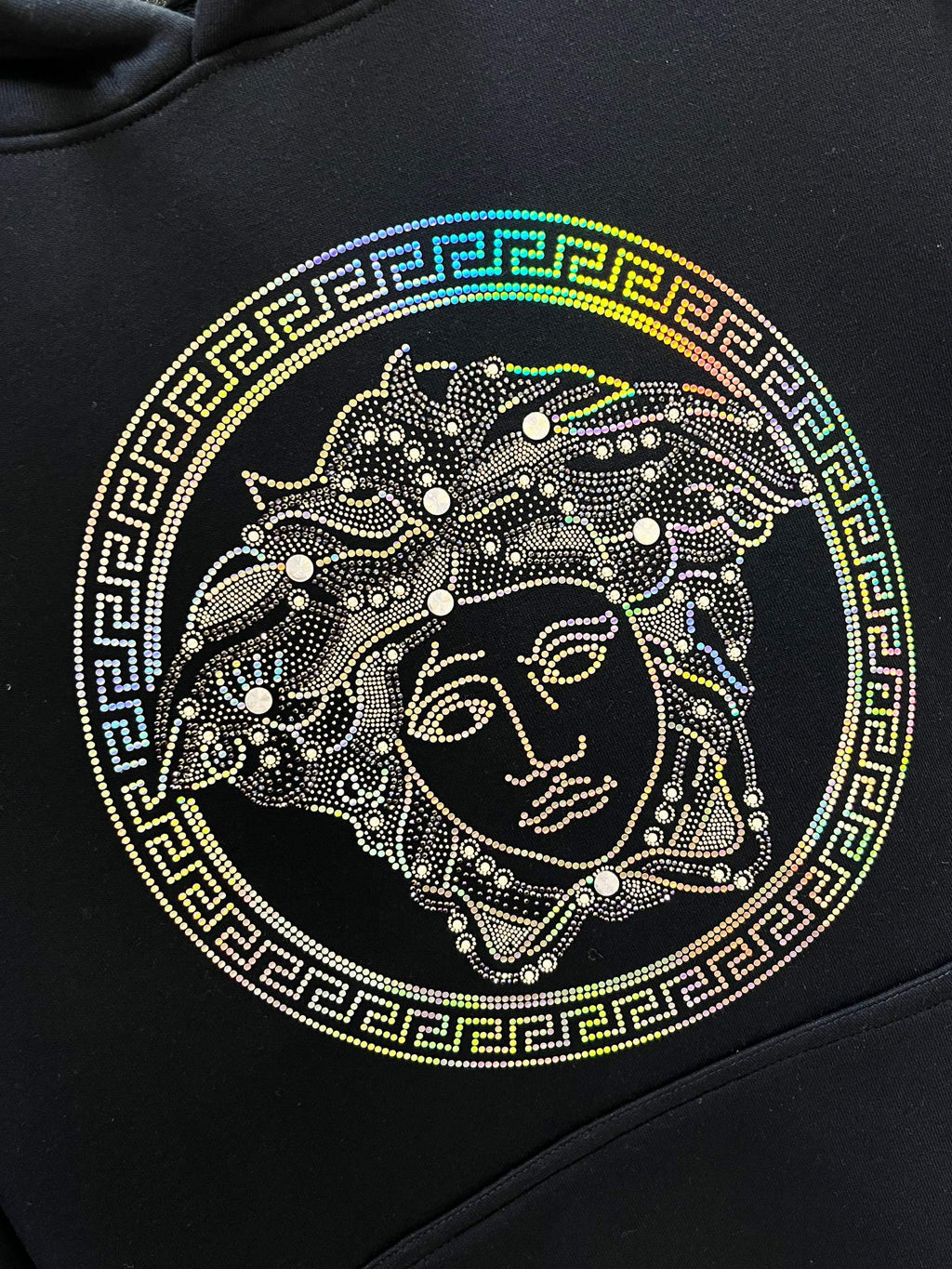 Versace Medusa face graphic on dark navy hoodie with Greek key border