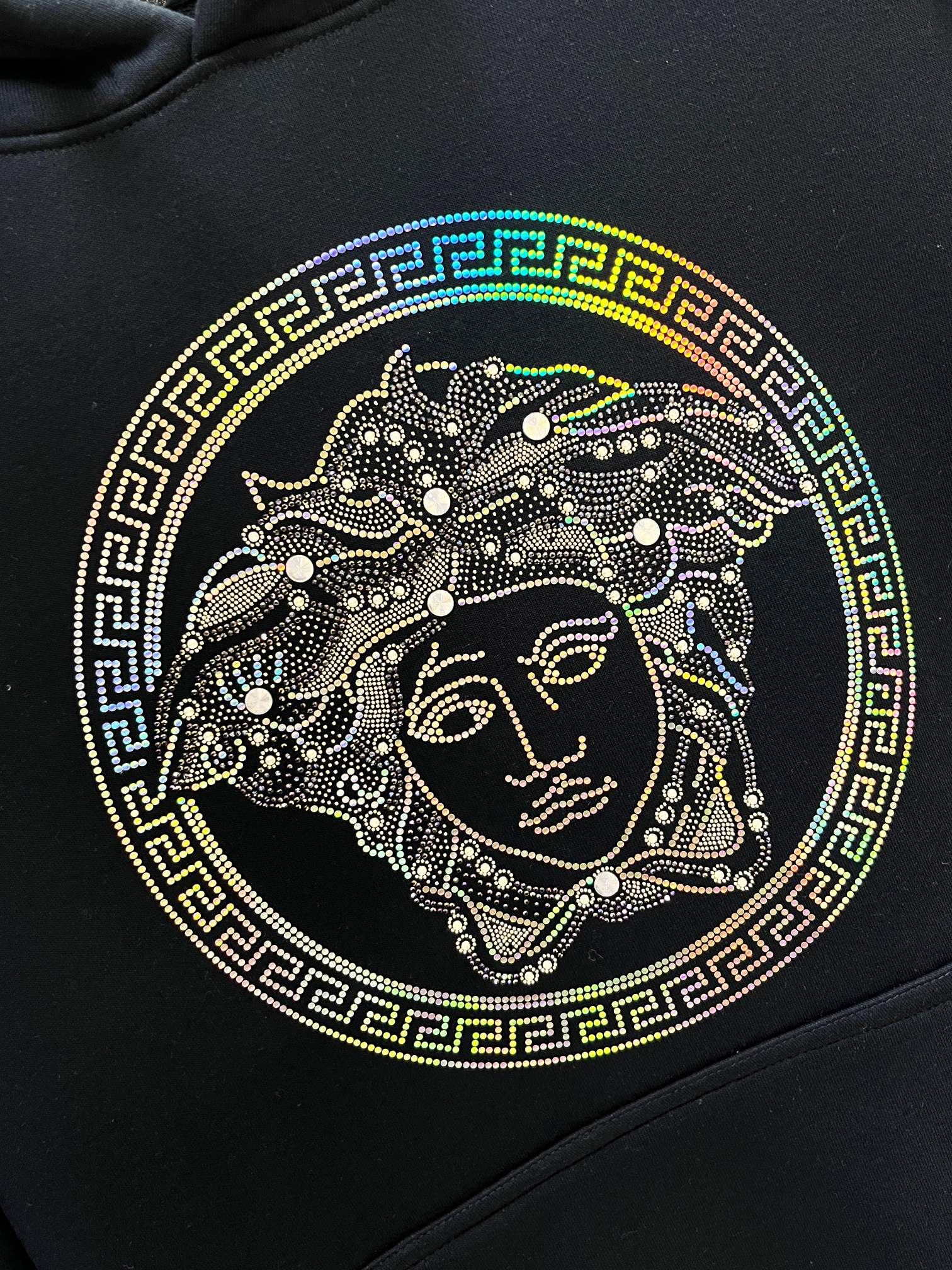 Versace Medusa face graphic on dark navy hoodie with Greek key border