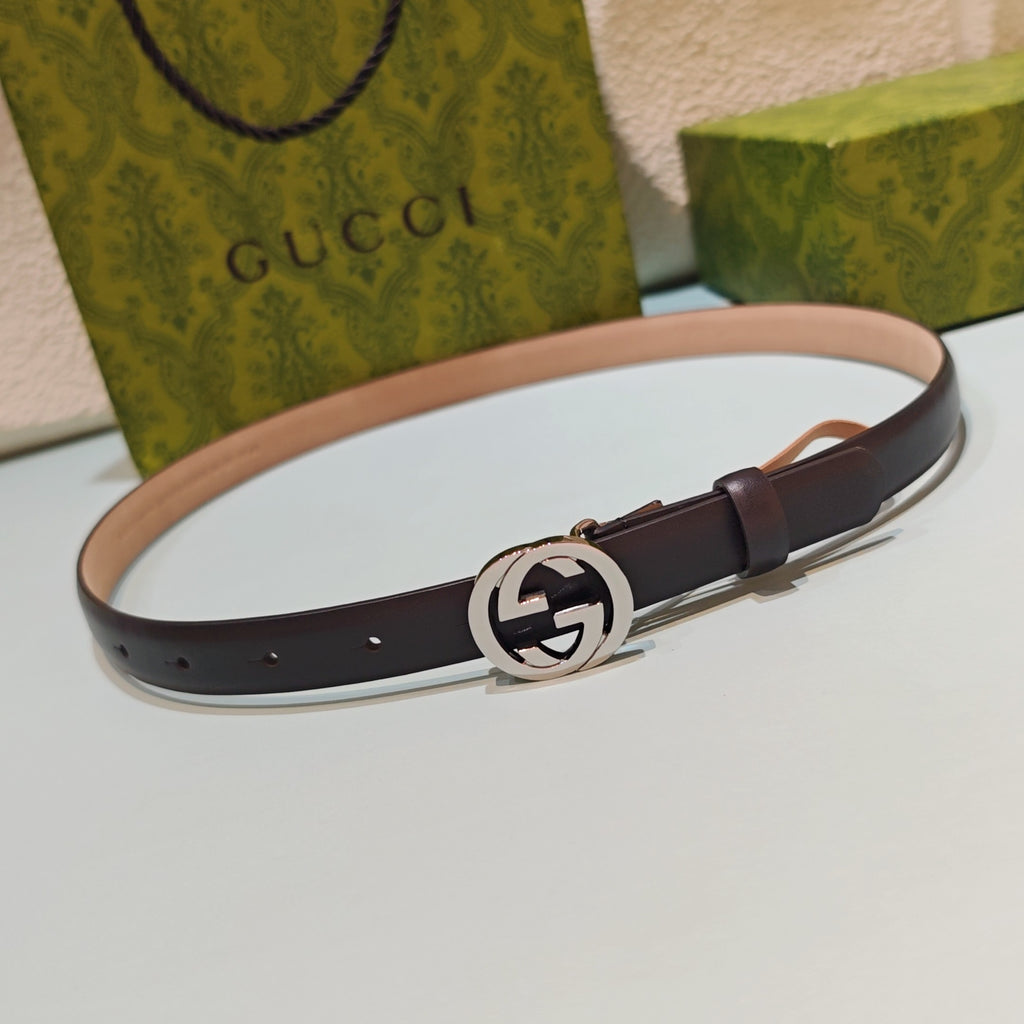 Gucci leather belt, dark brown, with round silver-tone GG buckle and keeper holes.