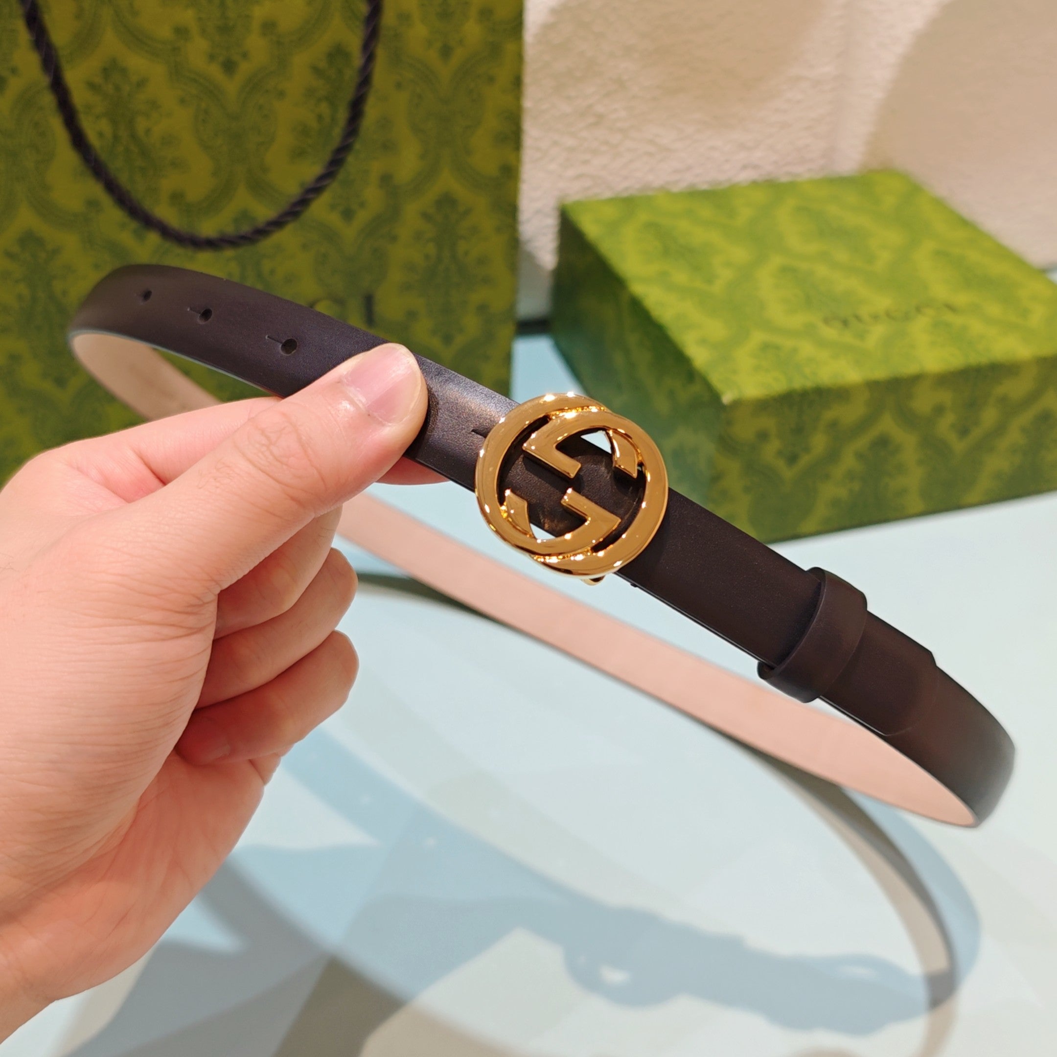 Gucci belt with gold-tone GG buckle, dark leather strap