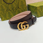 Gucci belt with dark strap and gold GG buckle, shown laid flat