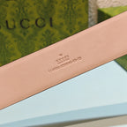 Tan leather belt strap with Gucci text imprint near the tip