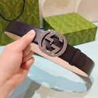 Gucci belt with dark leather strap and oval G buckle in silver-tone metal