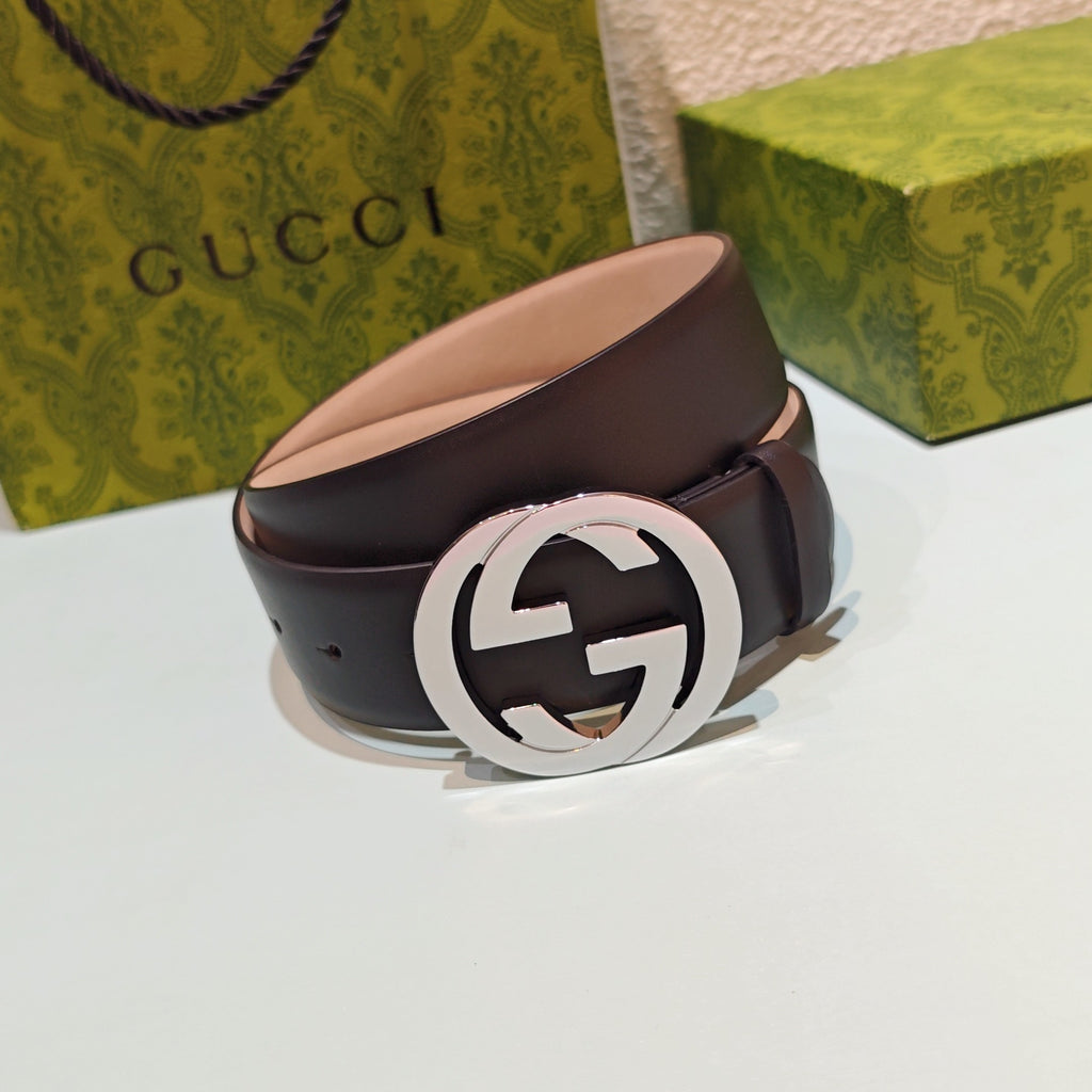 Dark leather belt with large round GG buckle and silver-tone clasp