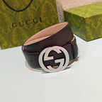 Dark leather belt with large round GG buckle and silver-tone clasp