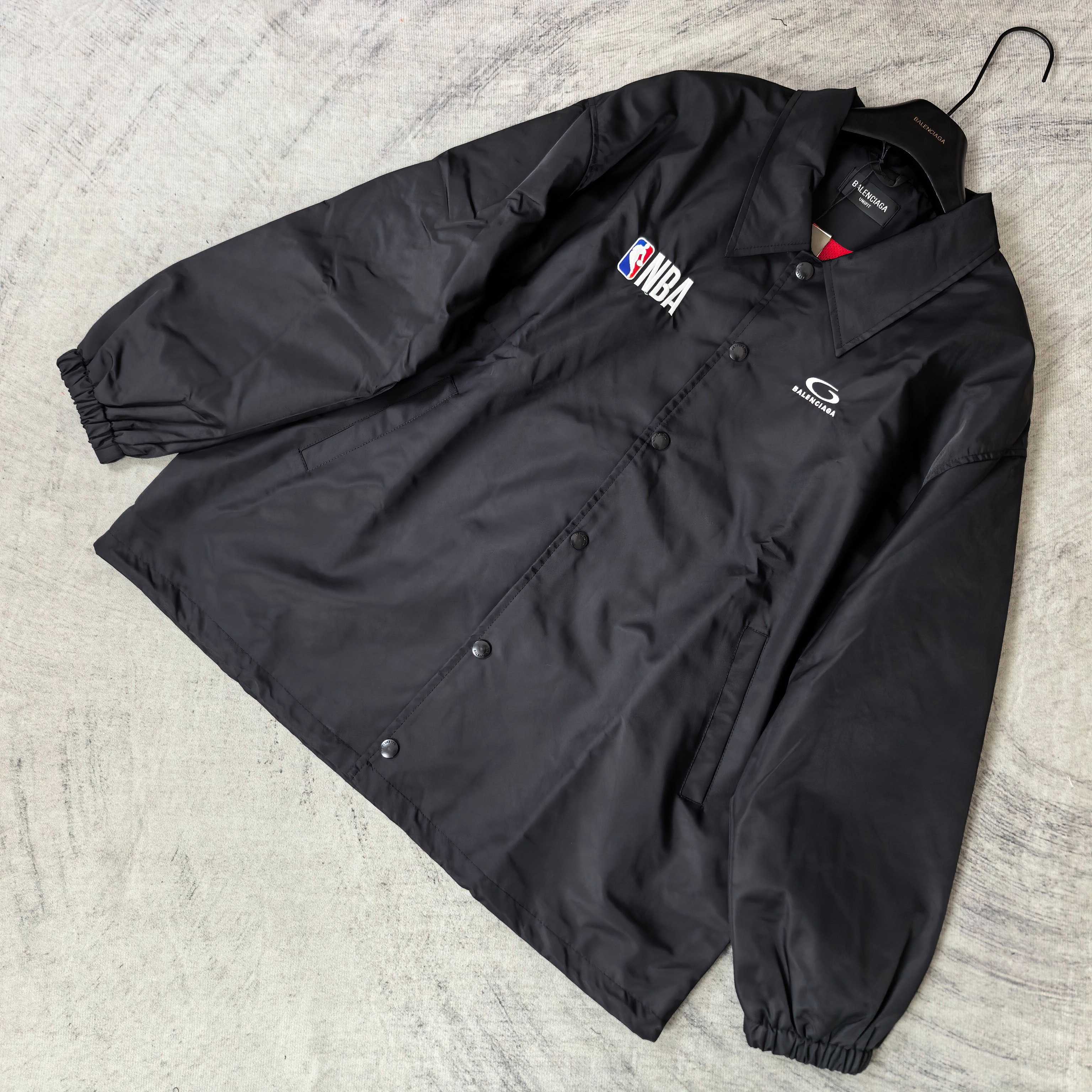 Dark navy jacket laid flat with button placket, spread collar, NBA patch and G logo