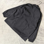 Dark navy jacket laid flat, button front details and elastic sleeve cuffs