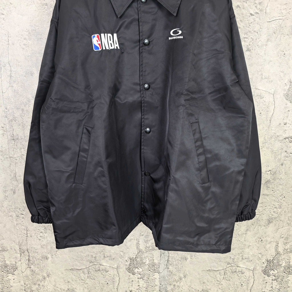 Dark navy short jacket front with button placket and elastic cuffs
