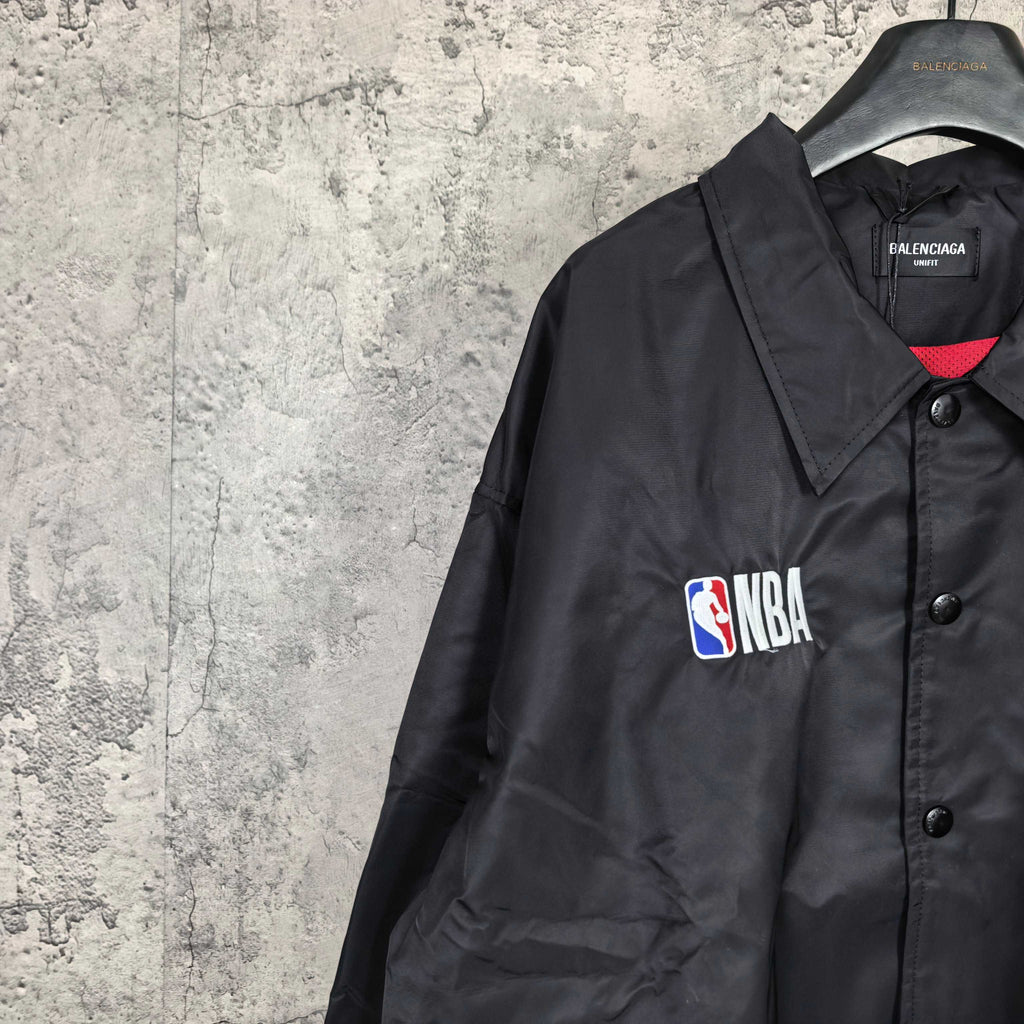 Dark navy jacket shoulder with NBA patch, button placket and red inner collar