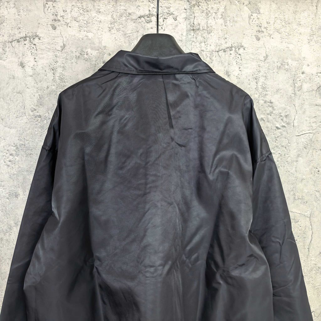 Dark navy long-sleeve jacket with raised collar and full back panel
