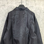 Dark navy long-sleeve jacket with raised collar and full back panel