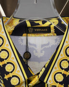 Versace shirt neckline close-up, gold trim and baroque print on black
