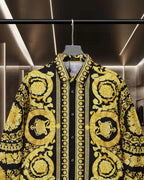 Versace button-up shirt front, gold ornate motifs on black with dark button placket