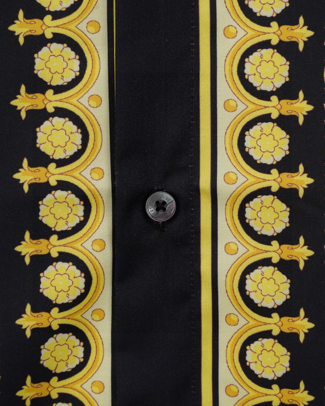 Versace shirt placket close-up, black with gold ornate border and button