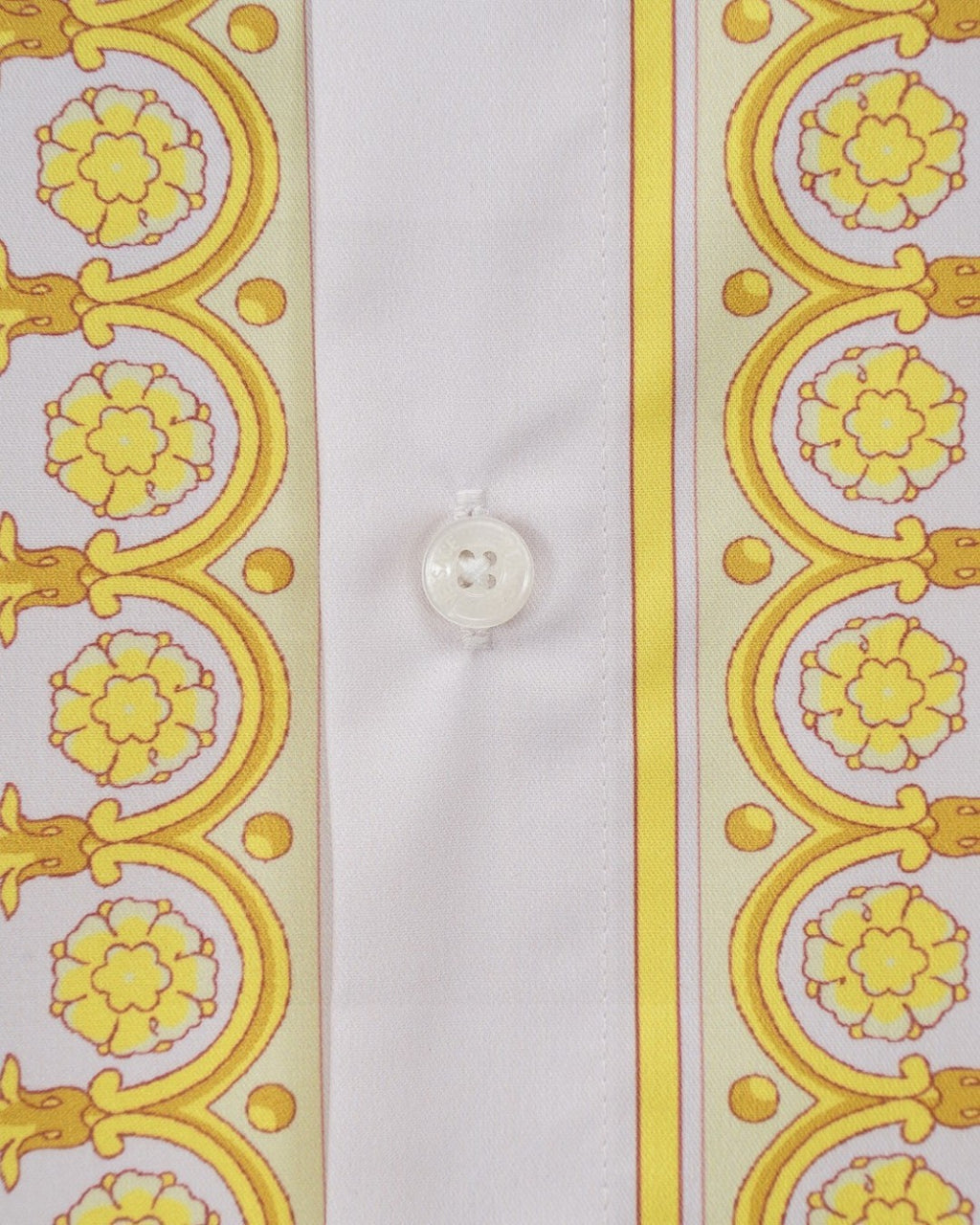 Versace shirt close-up of white button and yellow baroque side stripe panel