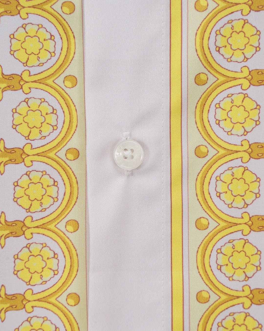 Versace shirt close-up of white button and yellow baroque side stripe panel