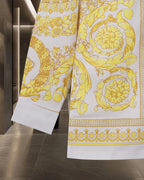 Versace shirt side view with yellow baroque print and patterned hem border
