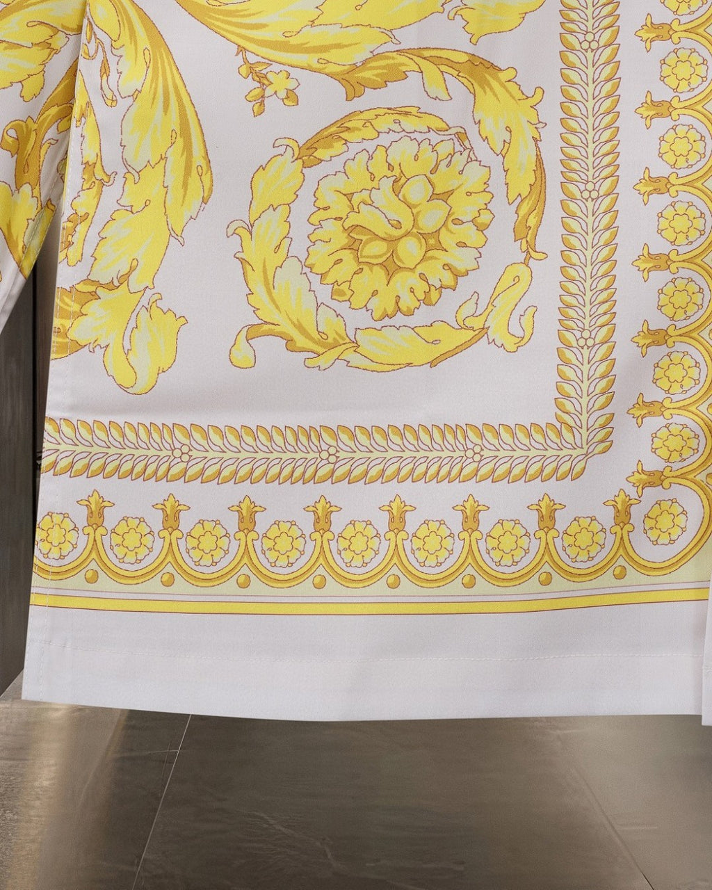 Versace shirt lower section with yellow border trim and ornate baroque motifs