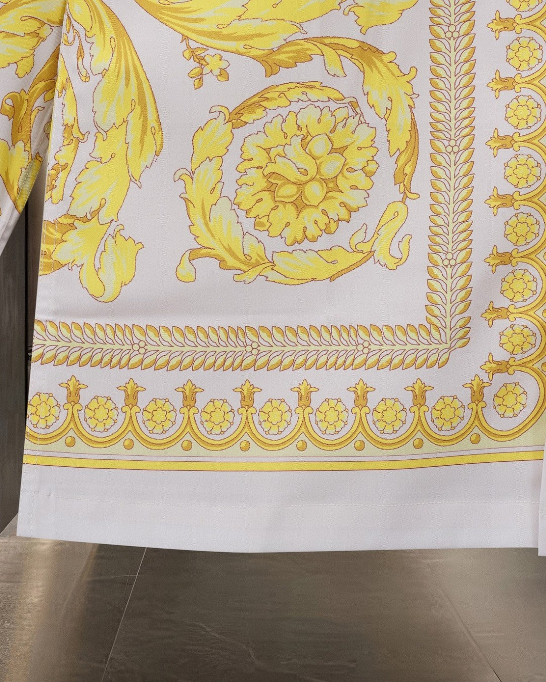 Versace shirt lower section with yellow border trim and ornate baroque motifs
