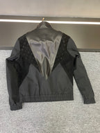 Back of Louis Vuitton jacket with V-shape monogram panel and logo emblem at yoke