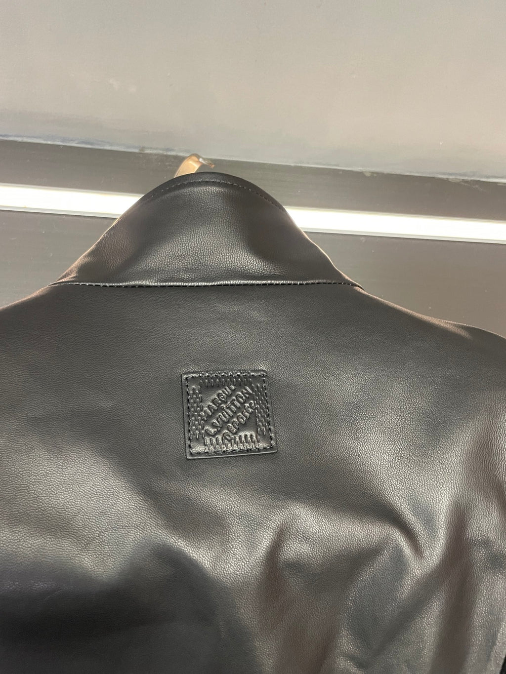 Back logo label patch on black Louis Vuitton jacket