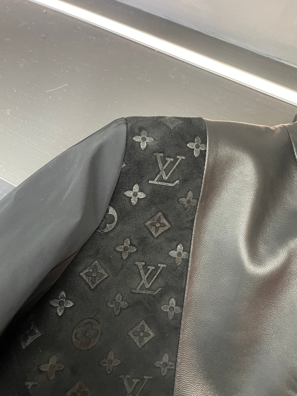 Louis Vuitton monogram pattern inset on black jacket sleeve/side panel