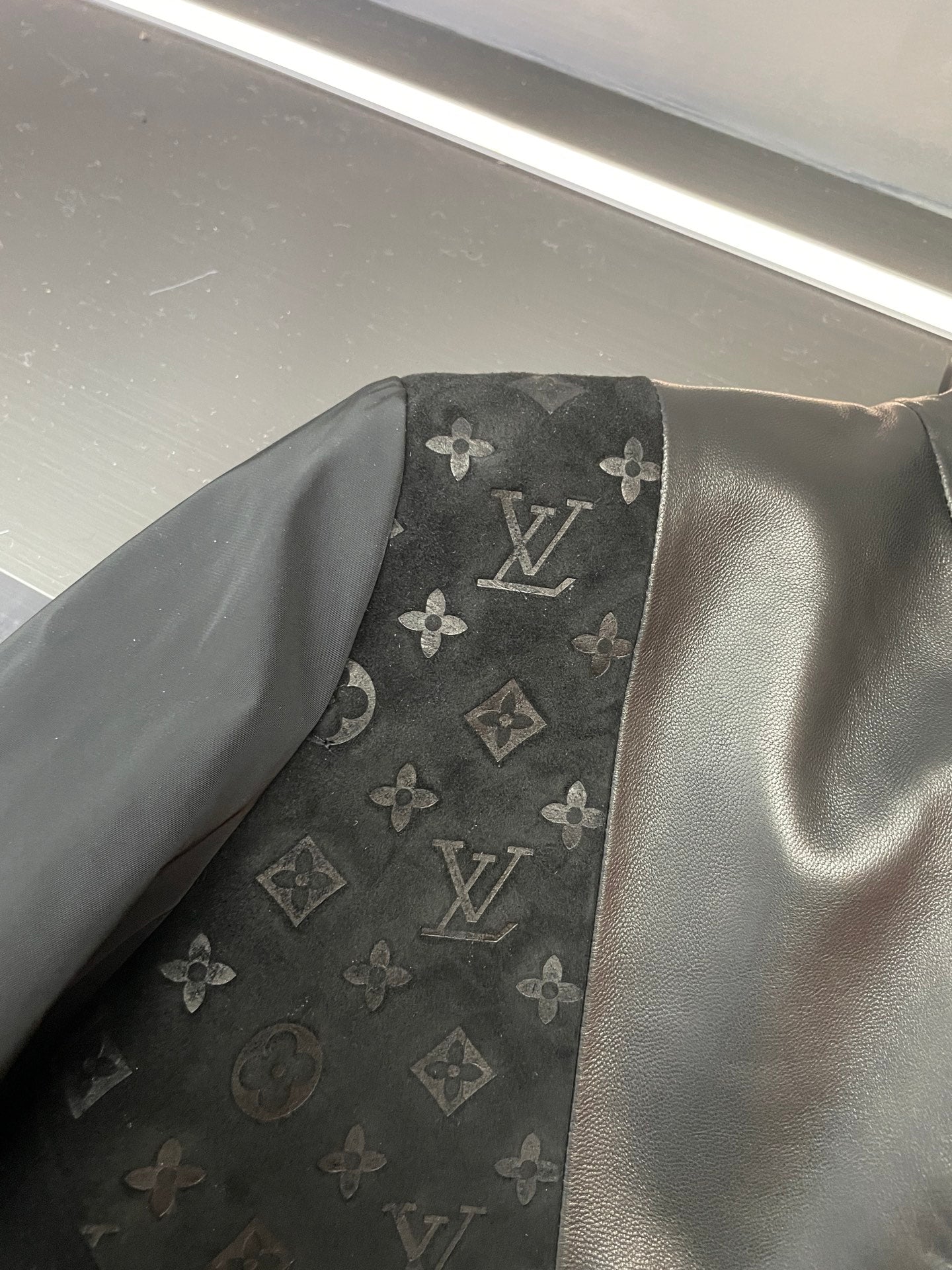 Louis Vuitton monogram pattern inset on black jacket sleeve/side panel