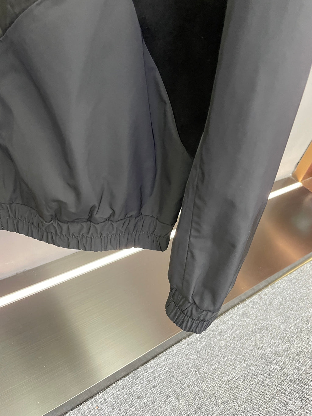 Louis Vuitton monogram windbreaker jacket, dark gray, elastic cuffs, close-up