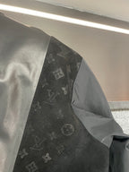 Louis Vuitton jacket interior side, showing black monogram panel and gray lining