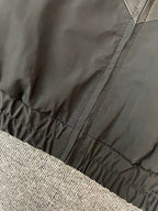 Black jacket hem with elastic cuff and stitched seams