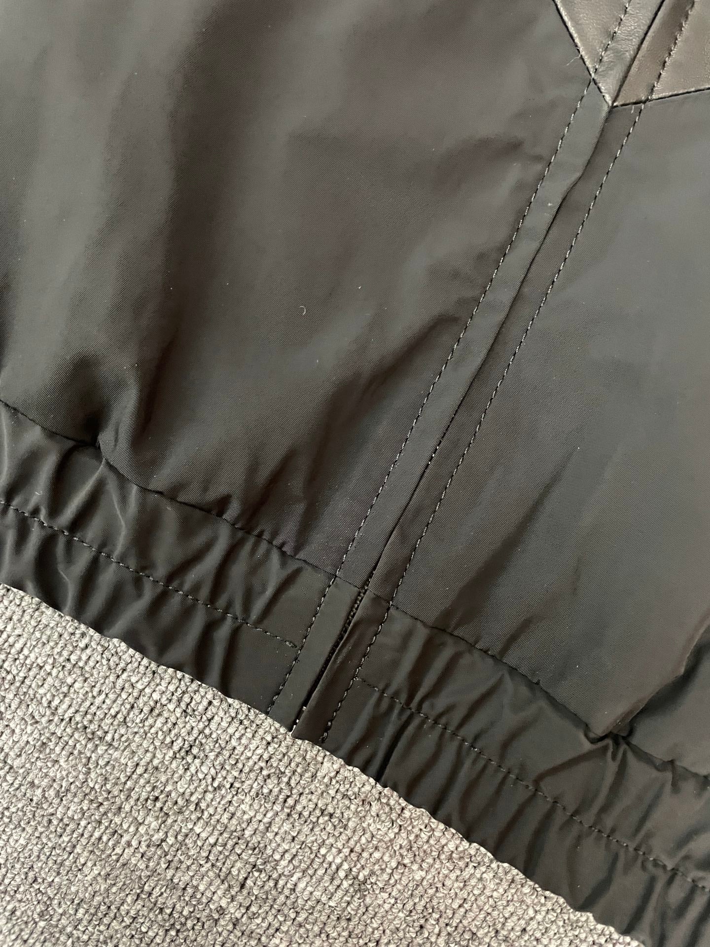 Black jacket hem with elastic cuff and stitched seams