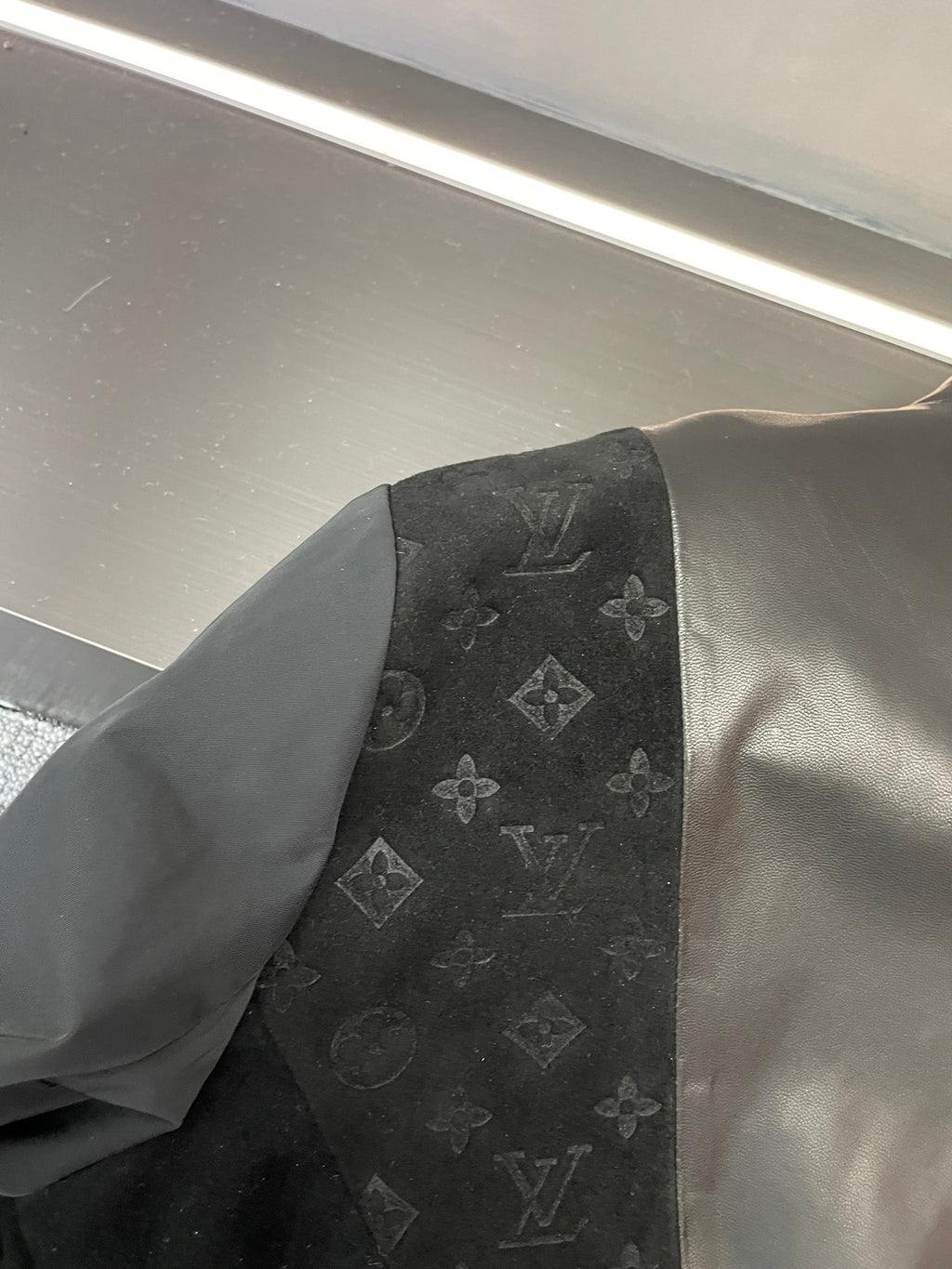 Black jacket sleeve panel with Louis Vuitton monogram print