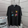 Black T-shirt with colorful splatter graphic on the front