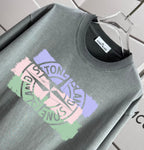 Sage gray crew-neck T-shirt with large front graphic detail.