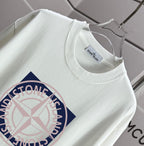 White T-shirt close-up: crew neck and partial front circular logo graphic