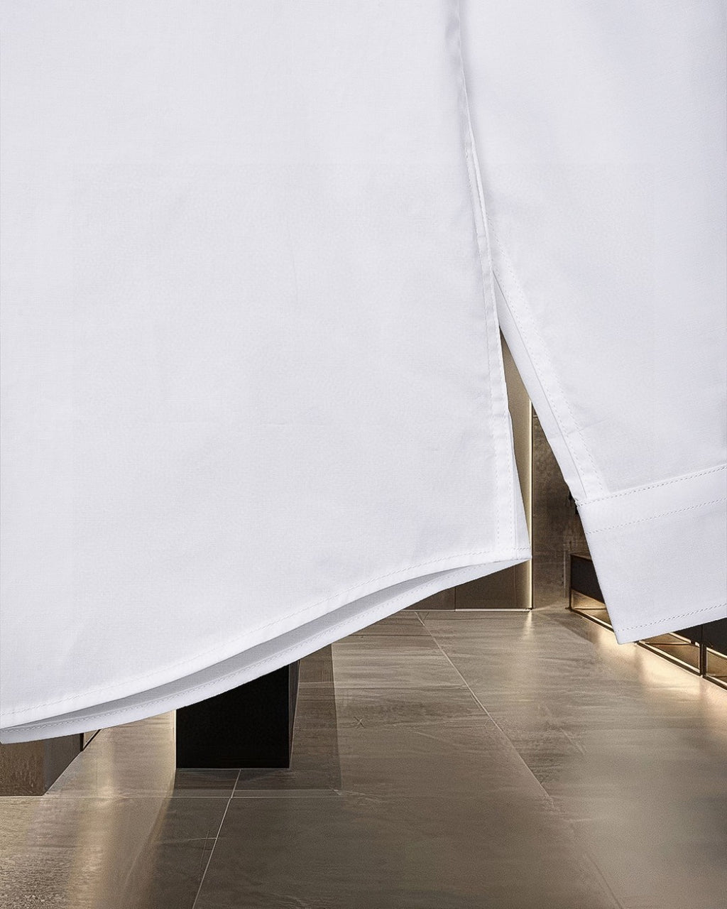 White long-sleeve button-up shirt with side split hem