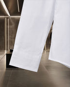 White long-sleeve button-up shirt with stitched hem