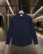 Navy long-sleeve button-up shirt with point collar and small chest logo