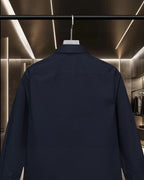 Navy long-sleeve button-up shirt back close-up on hanger