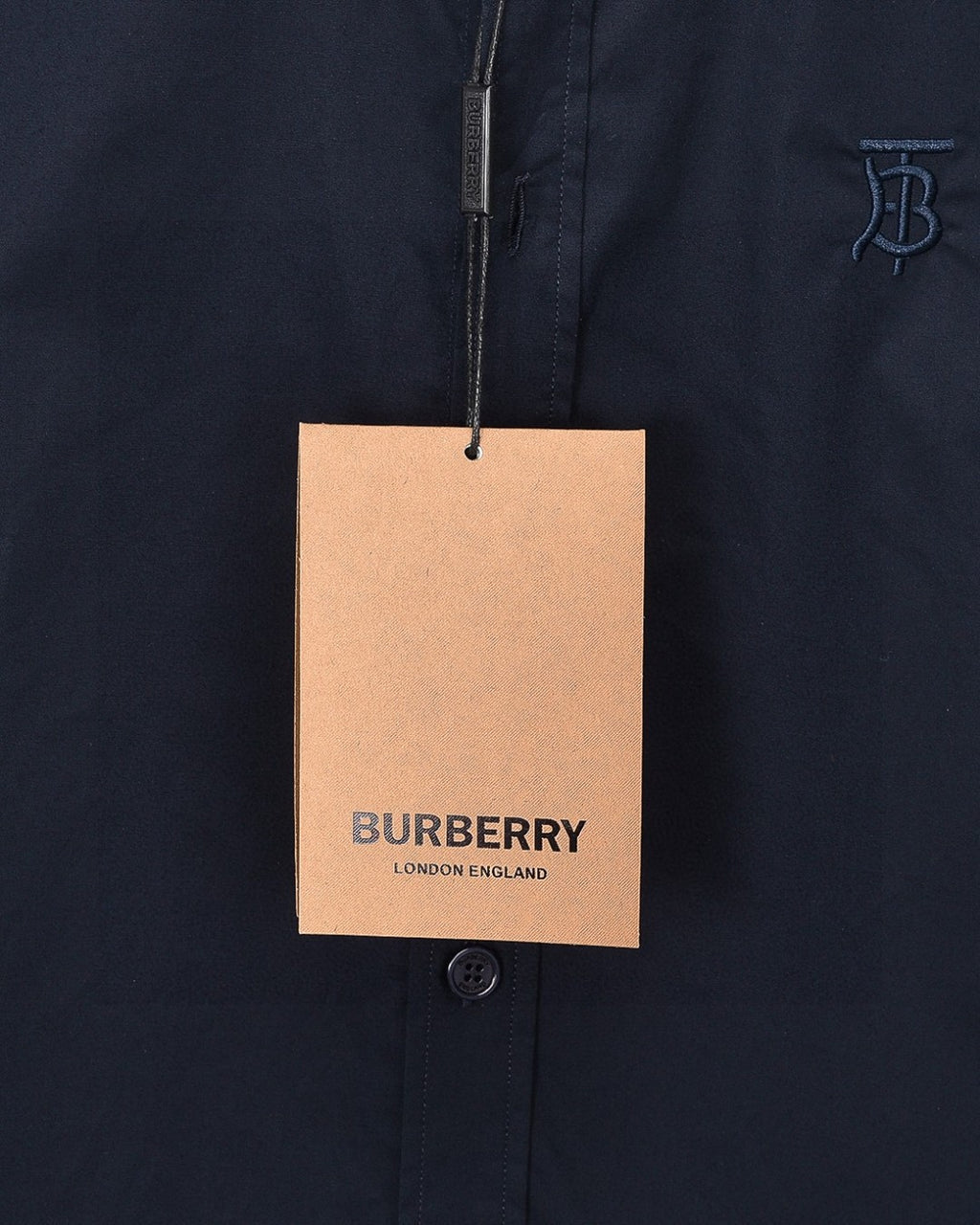 Burberry London England hangtag on navy button-up shirt
