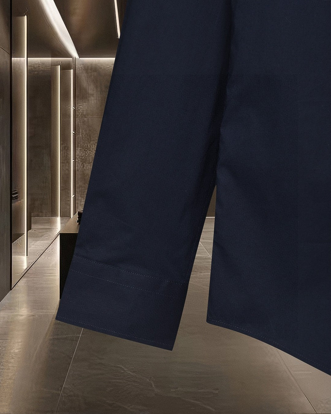 Long dark navy trousers with straight leg, visible hem and side seam