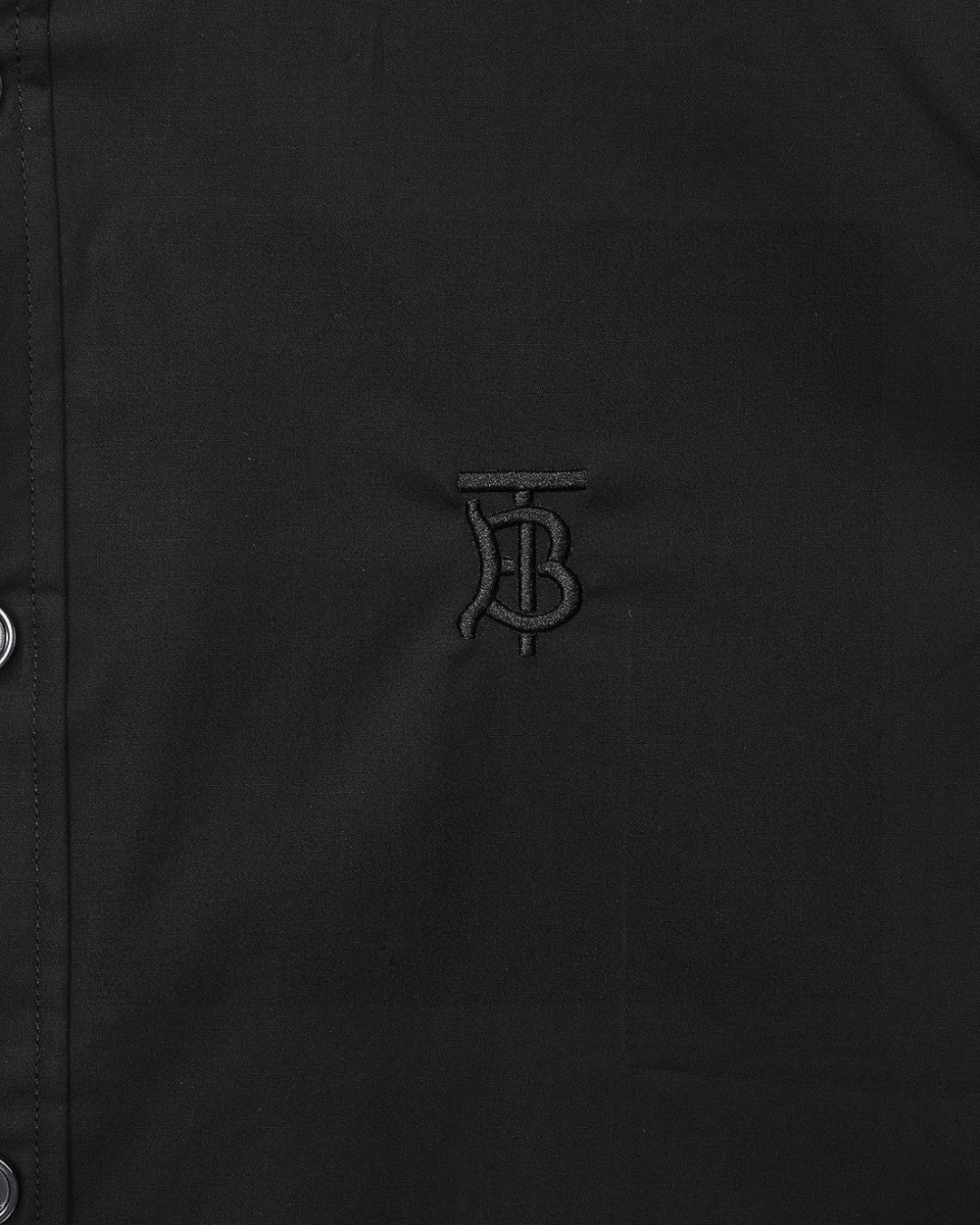 Burberry embroidered TB logo on dark button-up shirt front