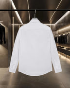 White long-sleeve button-up shirt, back view with buttoned cuffs