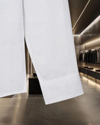 White long-sleeve button-up shirt sleeve hem detail