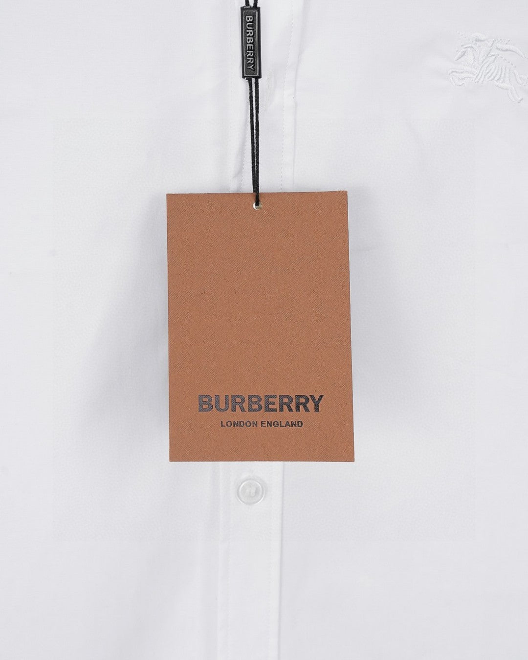 White long-sleeve button-up shirt with hanging brand tag
